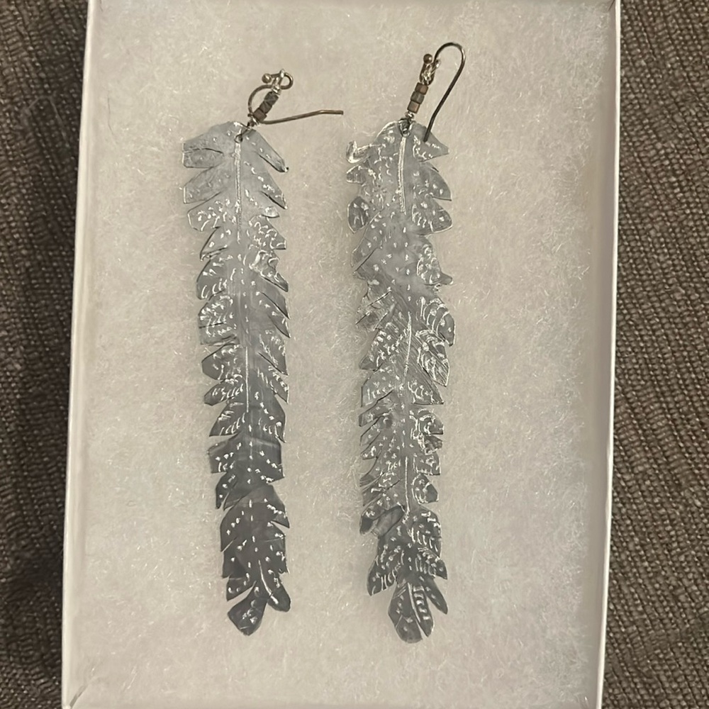 Beautiful silver metal cut feather earrings